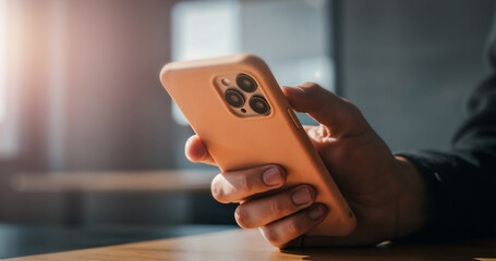 Close-up of hand holding smartphone. Capturing the modern habit of using technology in daily life — browsing the internet, checking social media, or reading the news.