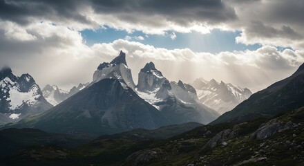 Fototapeta premium Patagonia Mountains Under Clouds and Sun – Dramatic Peaks, Shifting Light, and Majestic Wilderness in the Untamed Beauty of South America’s Iconic Landscape