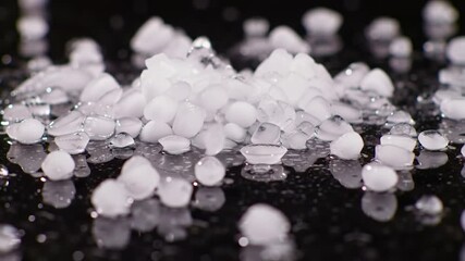 Pile of ice nuggets on black surface