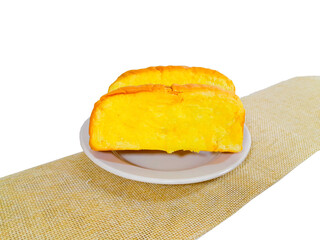 A slice of whole wheat bread with soft butter ready to be enjoyed for breakfast. Isolated background and close-up shot.
