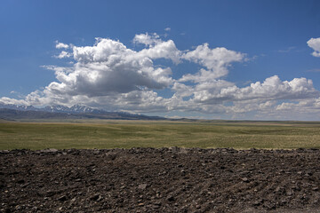 Spring steppe in Kazakhstan with rocky foreground