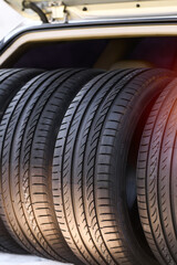 Set of summer tires inside open car trunk