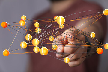 Abstract image of a hand interacting with a complex network of interconnected nodes, representing...
