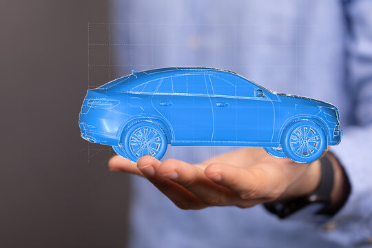 Futuristic car model in hand.  Concept of new vehicle technology and design.
