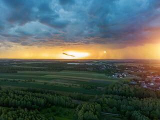 Sunset over countryside with dark storm clouds approaching