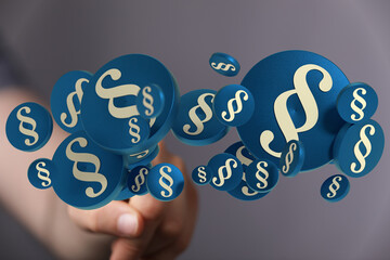 3D rendering of paragraph symbols floating towards a hand, symbolizing legal concepts, law, and...