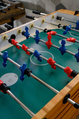 table football with figures of players in red and blue uniforms.