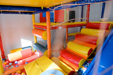 Play area for children. Slide and ball pit in the children's play center.