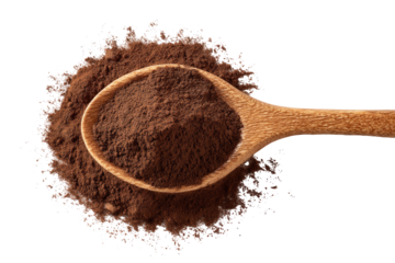 Wooden spoon filled with dark brown powder, surrounded by scattered powder