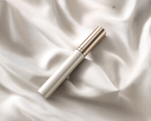 Elegant tube container with sleek design, positioned on soft satin fabric, showcasing luxurious aesthetic. neutral color palette enhances its sophisticated appeal
