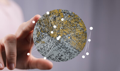 Hand holding a digital globe showing interconnected nodes. Represents global network,...