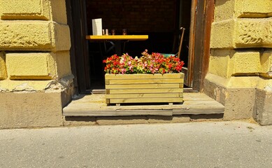 Pub with open door and wooden flower box.