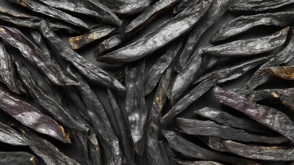 Fototapeta premium Burned French fries laid out in a flat lay on a dark surface. Acrylamide risk, food safety, carcinogens in food, unhealthy cooking, charred food health concerns