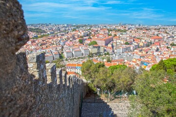 Old square with monument and trees in Lisbon