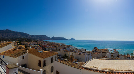 Panoramic view of Altea, Spain, showcasing white rooftops and coastline under a clear blue sky, capturing the beauty of coastal living and vibrant Mediterranean lifestyle.