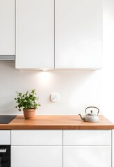Modern kitchen interior featuring white cabinets, wooden countertop, and a teapot.