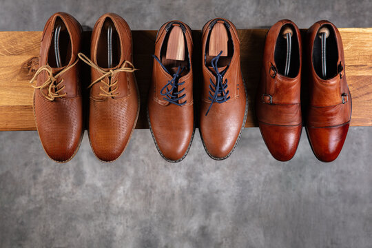 Elegant Brown Leather Shoes Collection on Wooden Shelf