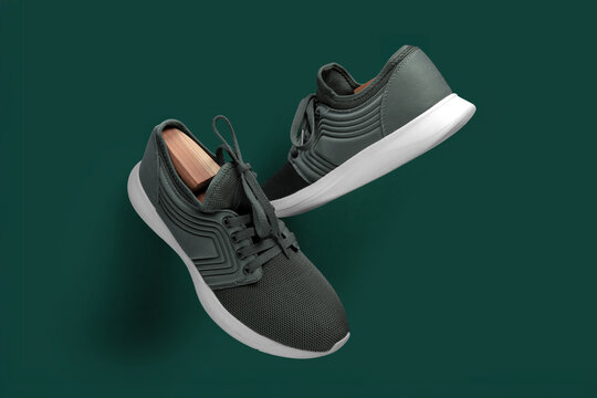 Modern Green Running Sneakers with White Soles on Green Background