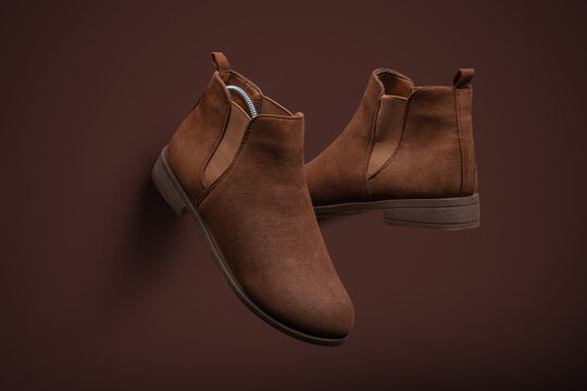 Stylish Brown Suede Chelsea Boots on Monochromatic Background