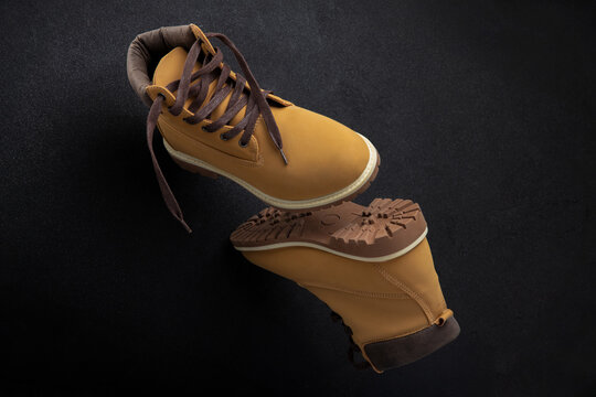 Yellow Hiking Boots with Rugged Soles on Dark Background