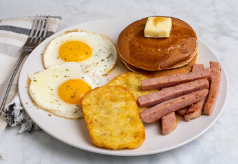 fried eggs with spam  fries and hash browns