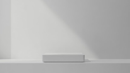 Minimalist white platform in a bright room with sunlight.