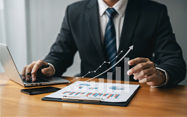 Businessman Analyzing Financial Growth with Laptop and Graph