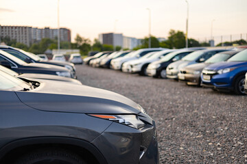 A row of cars parked in an outdoor lot, perfect for a car dealership or automotive advertisement.