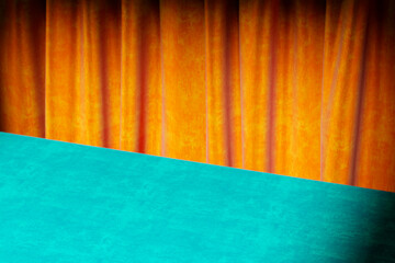 Luxury autumn velvet background for thanksgiving and halloween season. Vibrant orange and blue podium table interior room with curtains. Product placement mockup template for fall holiday display.