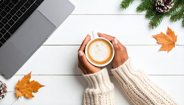 Female hands holding a cup of coffee on desk