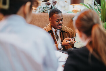 Colleagues collaborate and analyze data during a business meeting, emphasizing teamwork, strategy,...