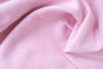 Cashmere pink stole. Texture, background, drapery. Fabric made of natural wool and silk, pastel pink color.