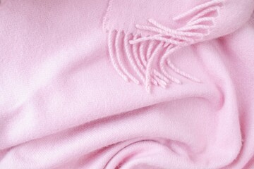Cashmere pink stole. Texture, background, drapery. Fabric made of natural wool and silk, pastel pink color.