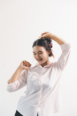 Asian woman rejoicing, looking happy, champion, fist pump gesture, standing over white background....