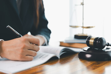 Justice and lawfirm concept. Female lawyer in office with brass scale. Woman hand gavel to bang....