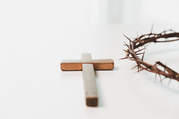 Cross and crown of thorns, often seen in gold crucifix symbols, represent the sacrifice of Jesus...