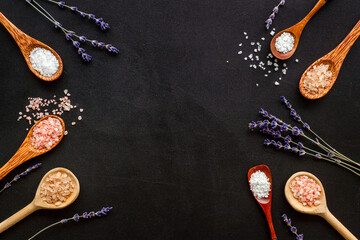 Obraz na płótnie Canvas Beauty spa therapy cosmetics and wellness flat lay - sea salt in many spoons with flowers, top view