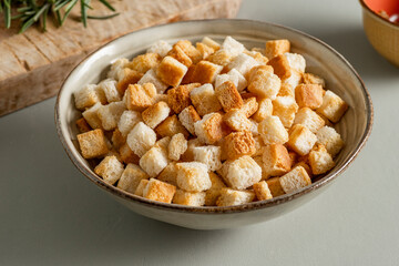 A bowl full of crunchy crostini with a golden, inviting surface, ready to add crunch to any dish.