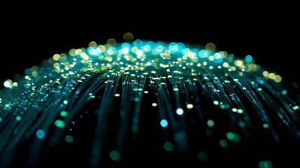 Abstract glowing fiber optic strands radiating light in teal and yellow.