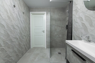 Bright Elegant Modern Minimalist Bathroom Interior Design of Shower Room With White Door, Gray Tile Walls, Shower, Sink