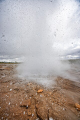 Strokkur Geysir erupting fountain of hot water and soaking cameraman in the Haukadalur geothermal area in Iceland on 9 June 2025