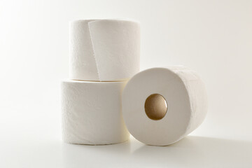 Three soft stacked toilet paper rolls white isolated background