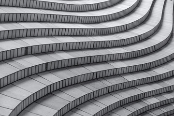 The curved concrete stairs create an abstract architectural pattern with geometric lines and a modern design