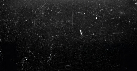 Black textured background with a mix of scratches and fine dust, offering a dramatic and realistic visual suitable for grunge or retro aesthetics.