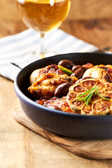 Grilled chicken pieces with kalamata olives and fresh rosemary. Close up.