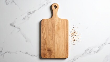 Fototapeta premium Wooden Cutting Board With Handle Hole on White Marble Surface and Breadcrumbs