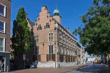 Obraz premium The historic Nijmegen City Hall, a magnificent example of Dutch Renaissance architecture, stands majestically under a clear blue sky, flanked by urban greenery. Nijmegen, Netherlands. 20 June 2025.