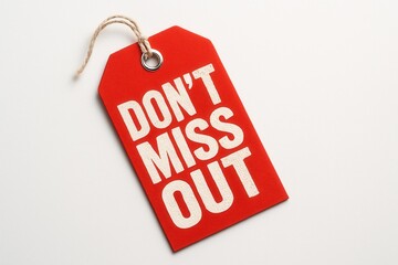 A bright red tag with a string and metal eyelet displaying the bold white text "DON'T MISS OUT" on a plain white background, conveying urgency and promotion.