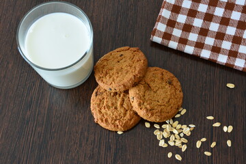 homemade oatmeal Cookies with chocolate chips and a glass of milk flat lay