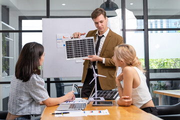 Architects and engineer team woman and man working on solar panel and blueprints with Solar...